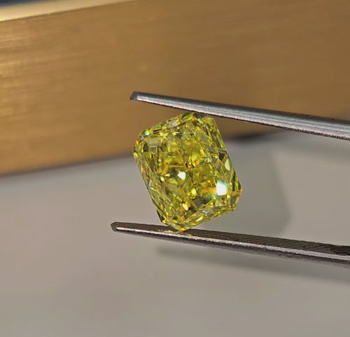 Unique GIA certified fancy vivid yellow elongated radiant cut diamond with flawless clarity.