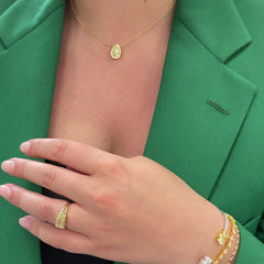 2.5 carat yellow diamond pear shape set in 18 karat yellow gold pendant with yellow diamond round  halo.