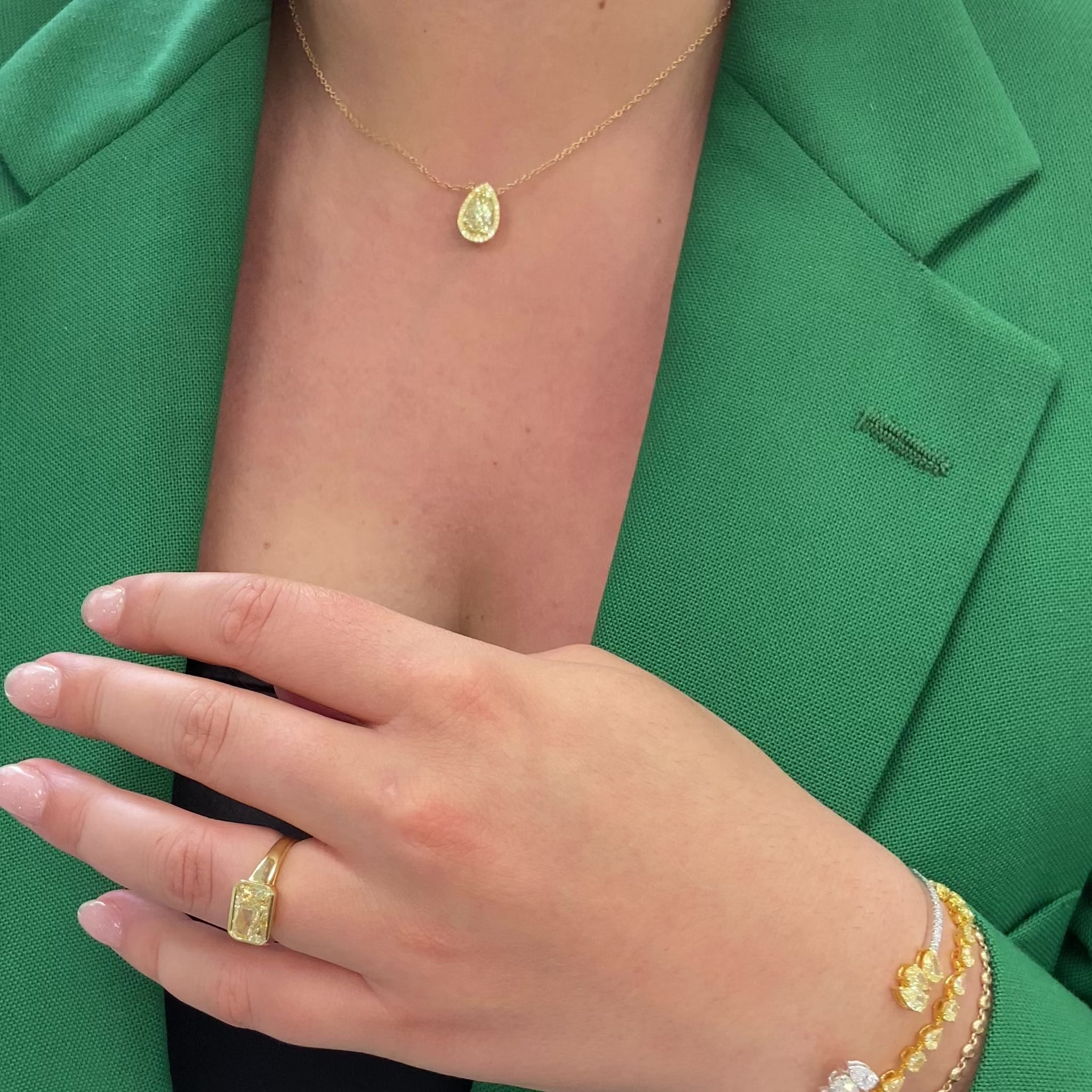 2.5 carat yellow diamond pear shape set in 18 karat yellow gold pendant with yellow diamond round  halo.