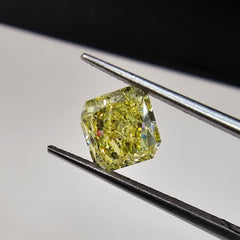 GIA certified elongated radiant cut natural yellow diamond with a unique and vibrant hue.