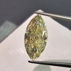 GIA certified Fancy Light Yellow elongated cushion cut diamond, VVS1 clarity and vivid color.