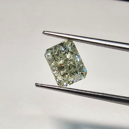 GIA certified Fancy Green-Yellow elongated radiant cut diamond with VVS2 clarity and vibrant color.