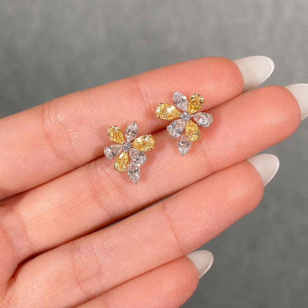 Fancy yellow and colorless pear diamond flower stud earrings in 18k gold - close-up detail | Rare Colors by Namdar, NYC