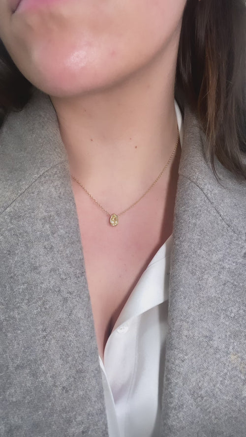 Bezel set diamond necklace. Pear diamond necklace. Simple diamond pendant. Yellow diamond pendant. Yellow diamond bezel set necklace. Everyday pear diamond pendant. Yellow diamond pear shape