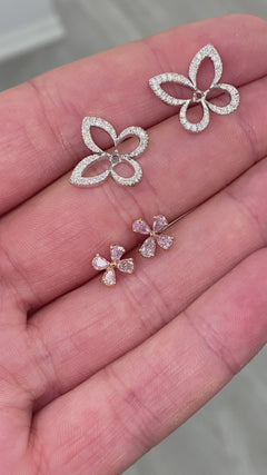 Delicate pink butterfly-shaped diamond stud earrings with a graceful and unique design.
