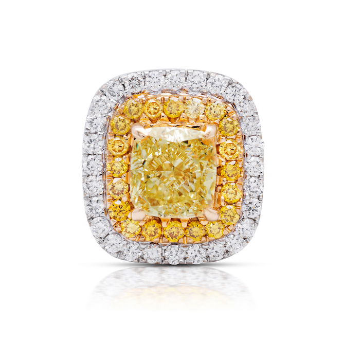 Classic diamond studs made bolder. In the center a vibrant fancy yellow cushion surrounded by a double halo. Fancy Yellow Cushion Studs 1.38 carat total diamond weight VS Clarity Center diamonds are 0.50ct each Surrounded by fancy yellow and white diamond. Set in 18k Gold