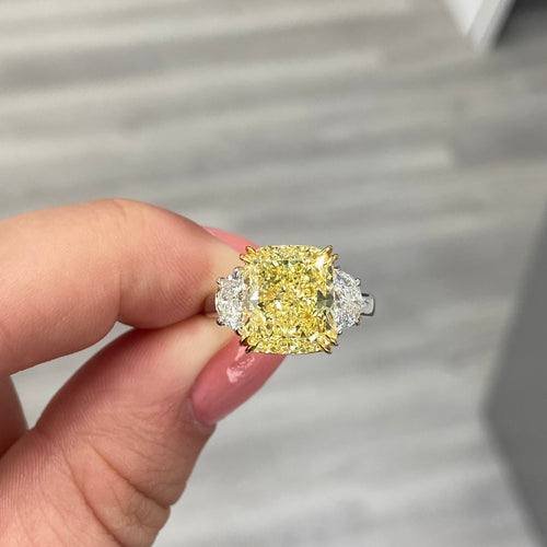 Elegant yellow diamond ring with a cushion-cut fancy yellow diamond and VS1 clarity.